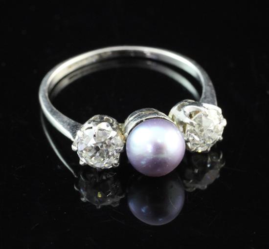 A platinum, three stone tahitian pearl and diamond ring, size K.